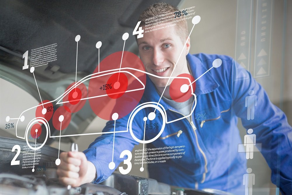 Mechanic reparing car while consulting interface